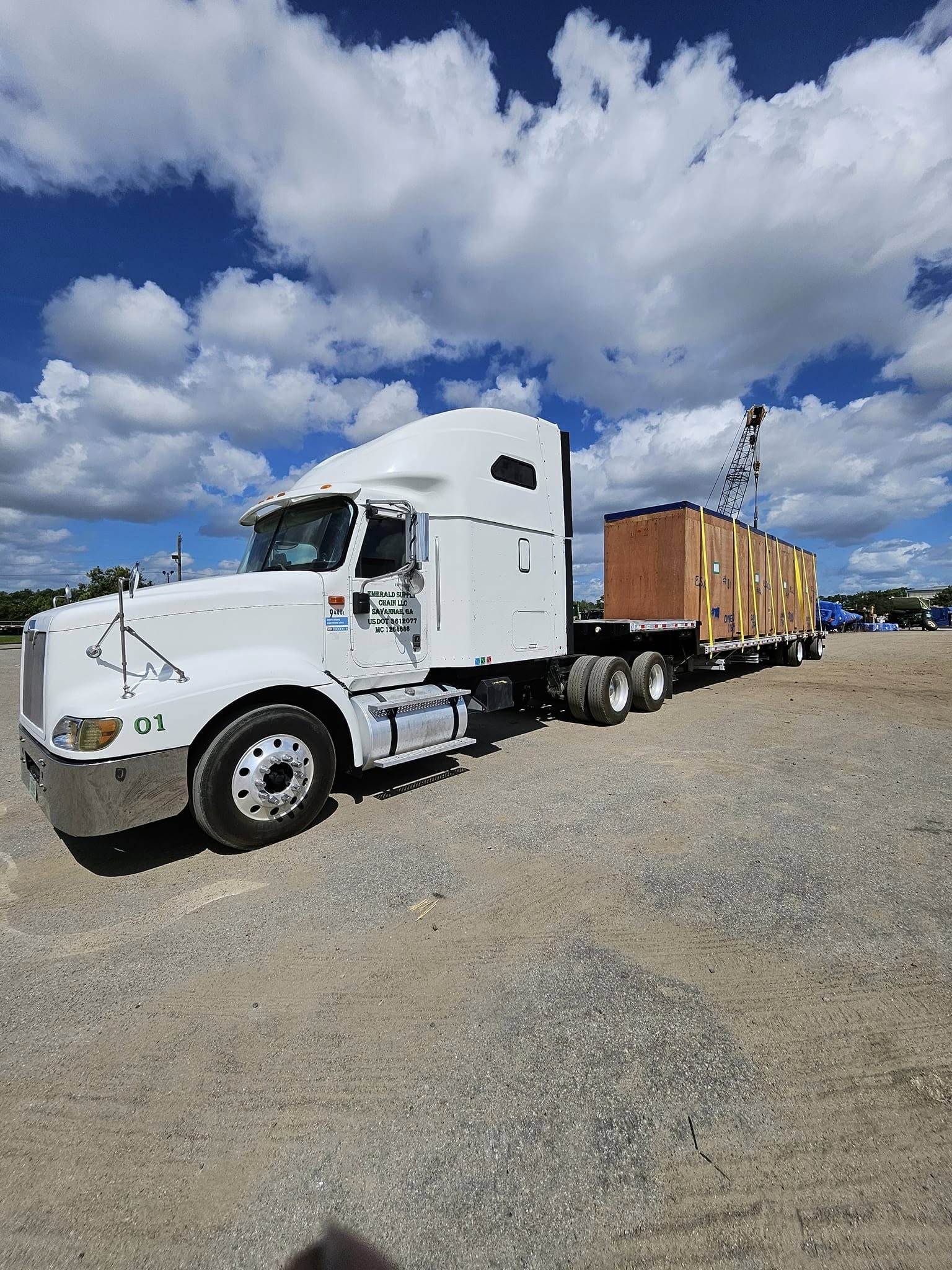 Emerald Supply Chain truck with flatbed trailer
